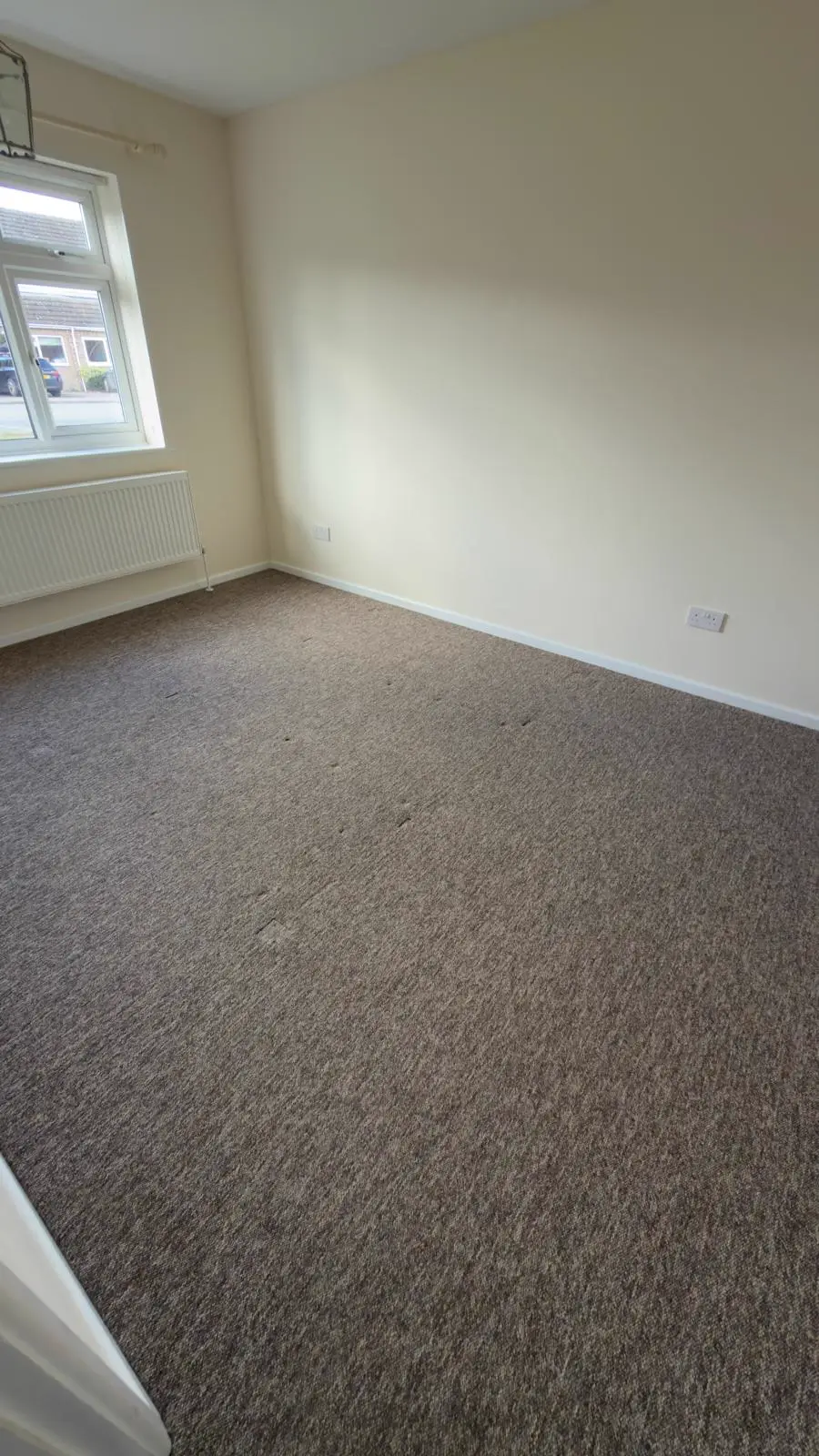 Empty room after end of tenancy cleaning with carpet and skirting visible
