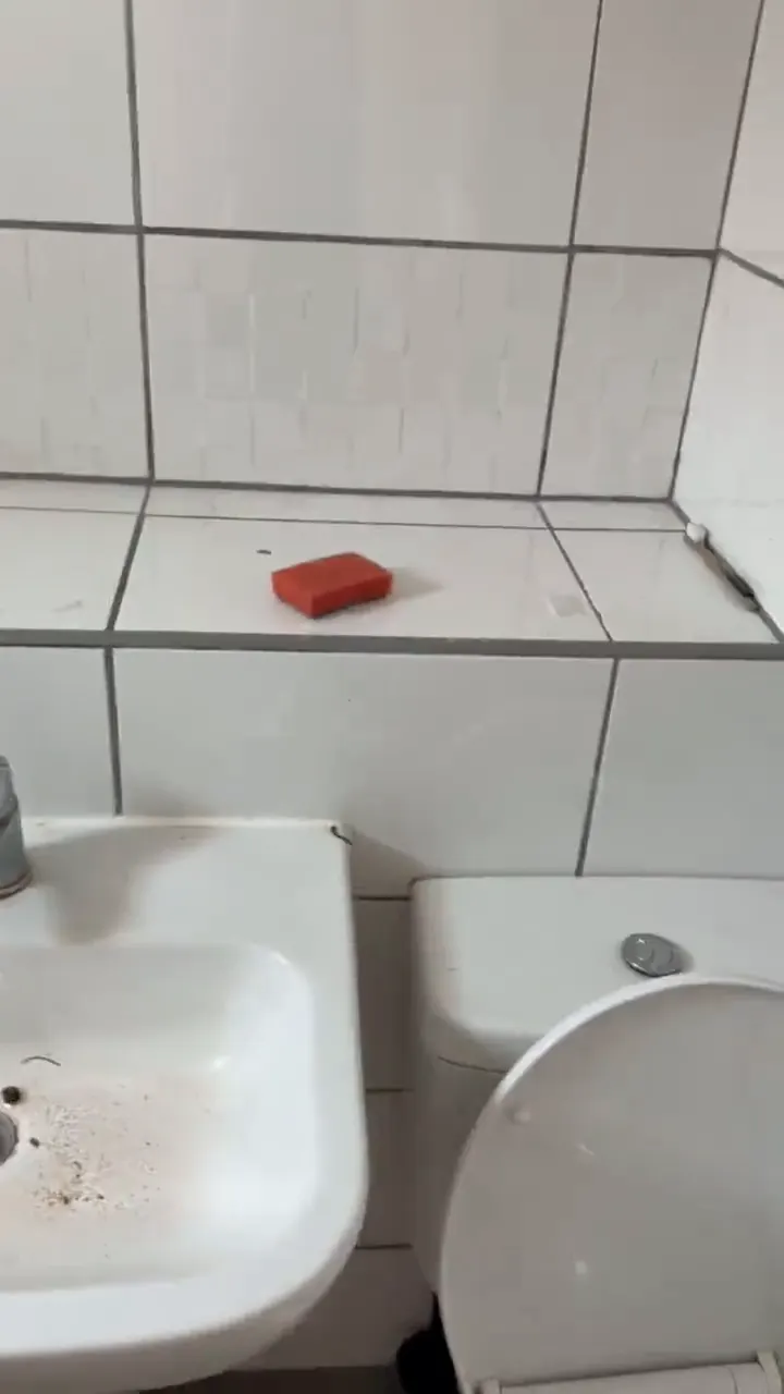 Bathroom basin, toilet and bath edge with marks and debris